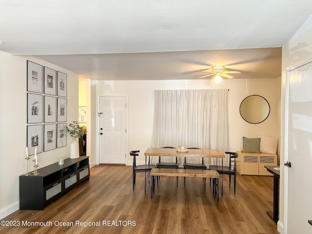 dining area featuring wood finished floors, baseboards, and ceiling fan