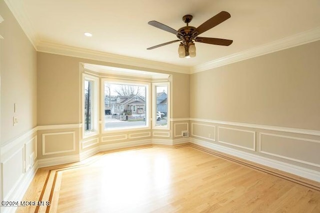 unfurnished room with crown molding, ceiling fan, and light hardwood / wood-style floors