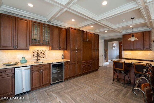 kitchen with pendant lighting, sink, parquet flooring, stainless steel dishwasher, and beverage cooler