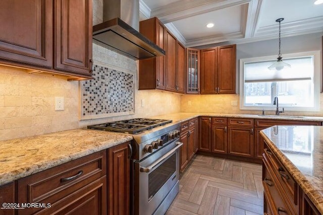 kitchen with pendant lighting, sink, high end stainless steel range oven, wall chimney exhaust hood, and light parquet flooring