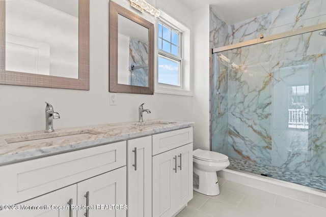 bathroom featuring toilet, dual bowl vanity, tile flooring, and an enclosed shower