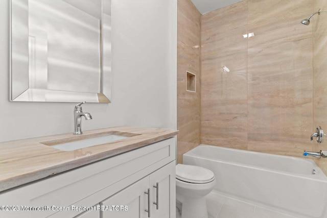 full bathroom featuring tile flooring, oversized vanity, toilet, and tiled shower / bath