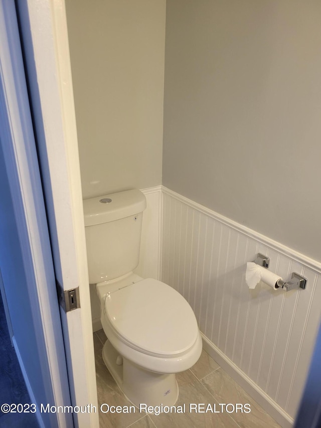 bathroom featuring toilet and tile floors