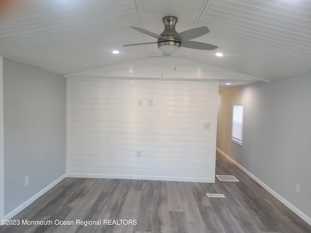 empty room with ceiling fan, hardwood / wood-style floors, and lofted ceiling