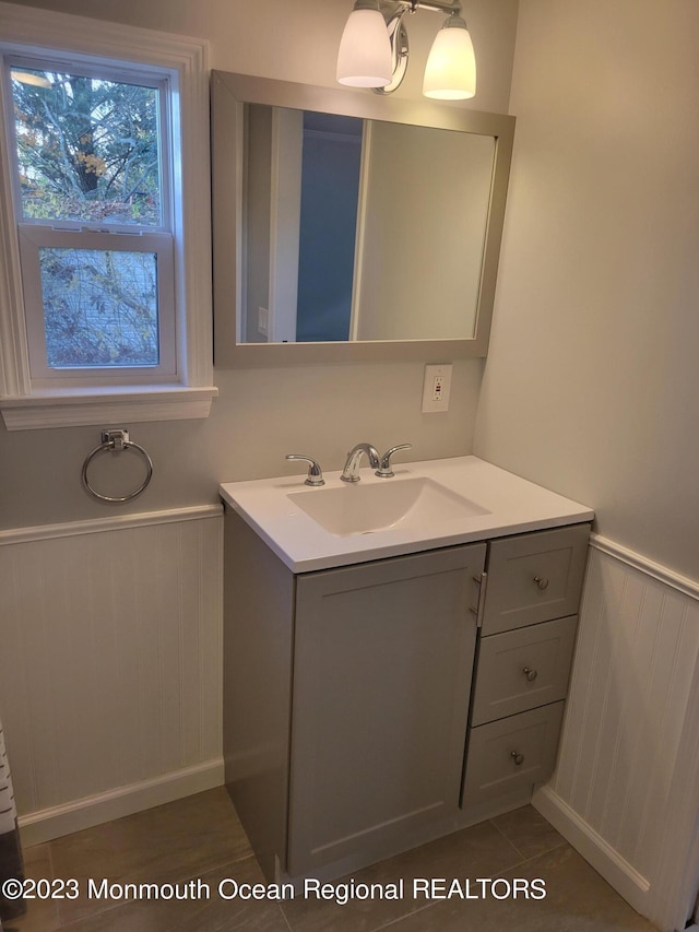 bathroom with tile flooring and vanity