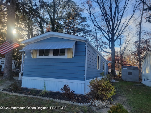 view of side of property with a storage unit