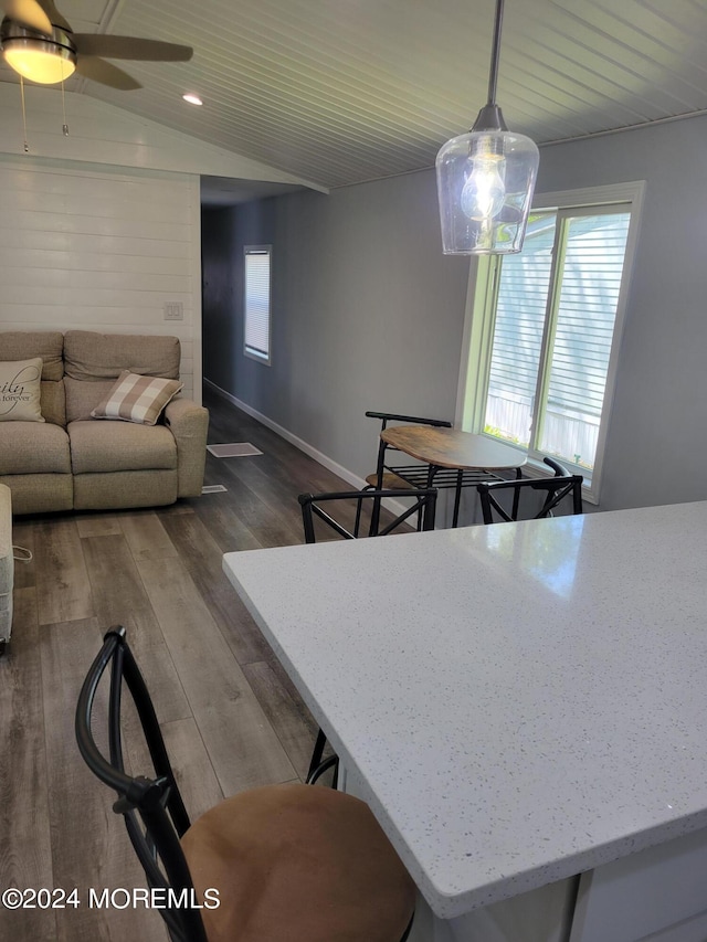 dining area featuring dark wood-type flooring, lofted ceiling, and ceiling fan