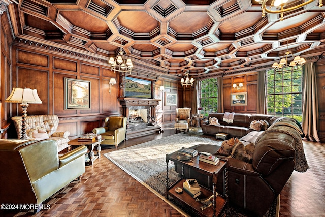 living room featuring crown molding, a fireplace, a chandelier, and parquet flooring