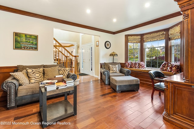 living room with dark wood-type flooring and ornamental molding