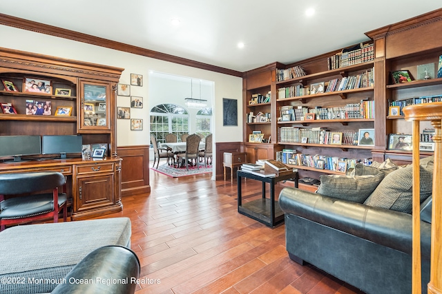 interior space with ornamental molding and wood-type flooring