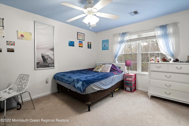 bedroom with ceiling fan and light colored carpet