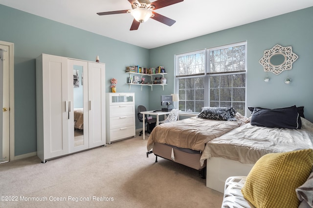 carpeted bedroom with ceiling fan