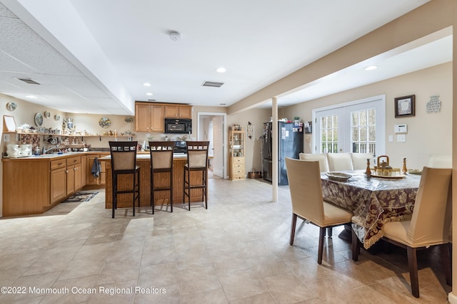 tiled dining area with french doors and bar