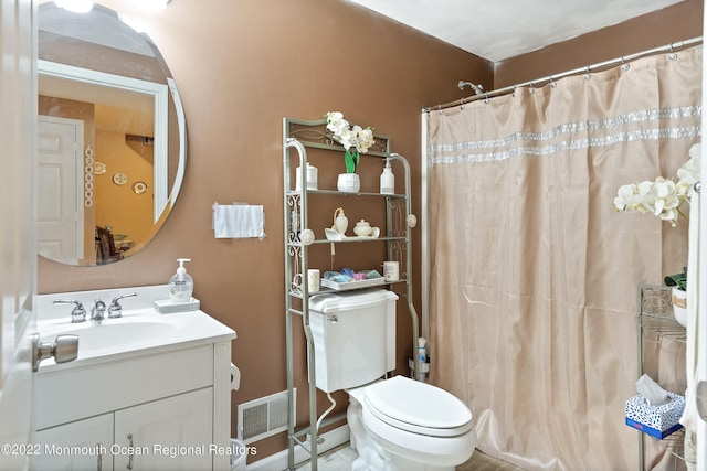 bathroom with tile flooring, toilet, and vanity