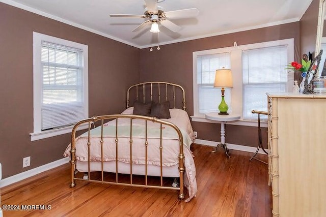 bedroom featuring wood-type flooring, ceiling fan, and crown molding