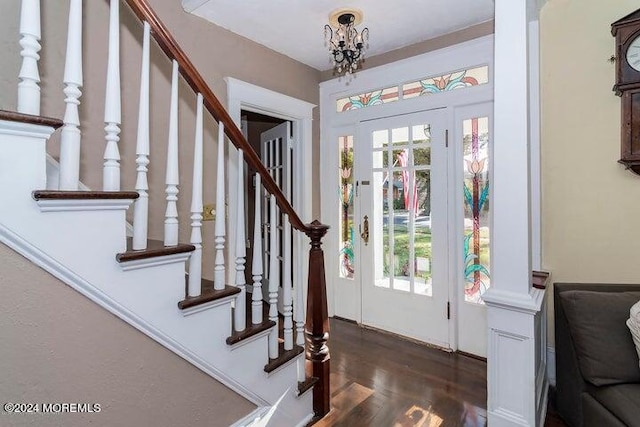 entrance foyer featuring plenty of natural light, dark hardwood / wood-style floors, and an inviting chandelier