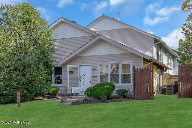 view of front facade featuring a front lawn and central AC unit