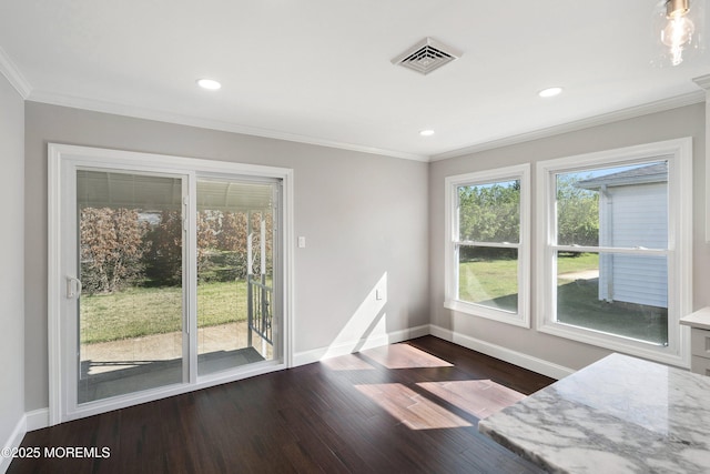 unfurnished dining area featuring crown molding, baseboards, and visible vents
