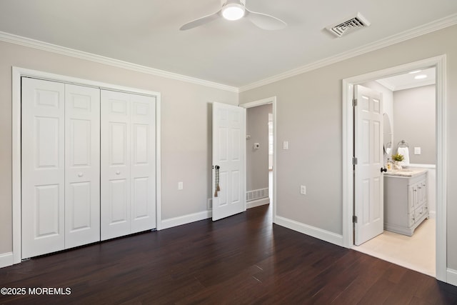 unfurnished bedroom with visible vents, wood finished floors, baseboards, a closet, and ornamental molding