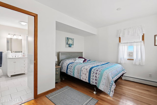 bedroom featuring ensuite bathroom, light tile flooring, and sink