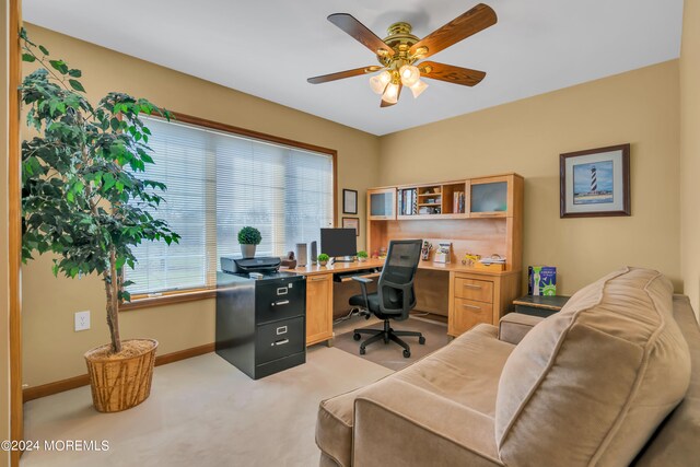 office area featuring light carpet and ceiling fan