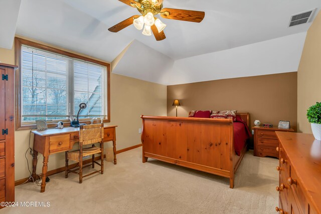 bedroom with light colored carpet, vaulted ceiling, and ceiling fan