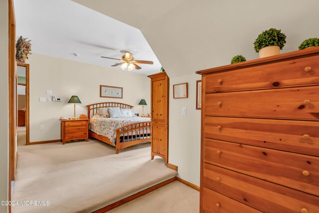 bedroom with light carpet and ceiling fan