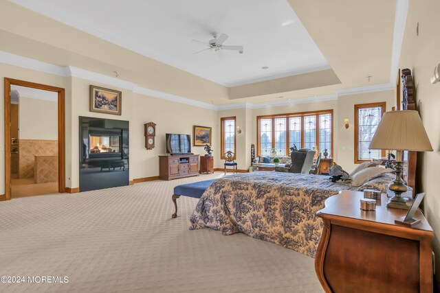 carpeted bedroom featuring a multi sided fireplace, crown molding, and ceiling fan