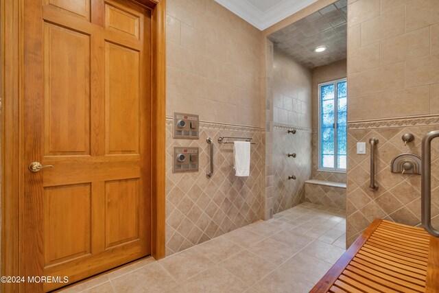 bathroom featuring a tile shower, tile walls, ornamental molding, and tile patterned flooring