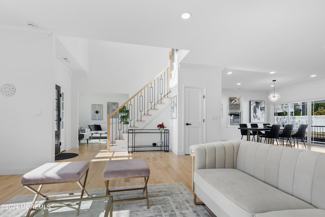 living room featuring light wood-type flooring and crown molding