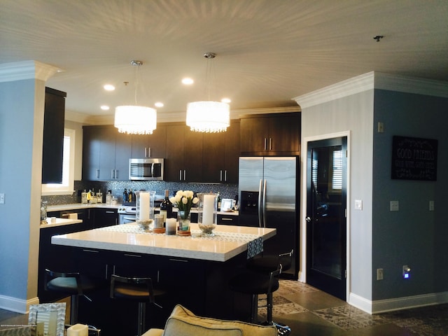 22 Cooper Ave Unit 105, Long Branch, NJ 07740 - kitchen with decorative light fixtures, appliances with stainless steel finishes, dark brown cabinetry, backsplash, and a kitchen breakfast bar