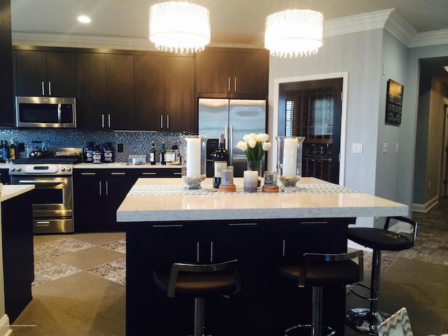 22 Cooper Ave Unit 105, Long Branch, NJ 07740 - kitchen with backsplash, appliances with stainless steel finishes, a center island, light stone countertops, and decorative light fixtures