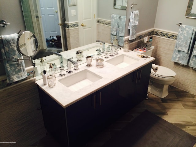 22 Cooper Ave Unit 105, Long Branch, NJ 07740 - bathroom featuring double sink vanity, toilet, and wood-type flooring