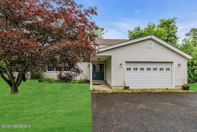 view of front of house with a front lawn and a garage