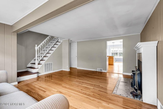 living room featuring hardwood / wood-style floors and crown molding