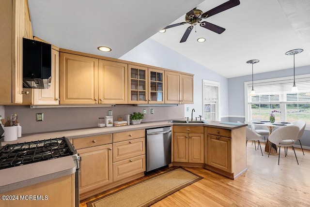 kitchen with pendant lighting, sink, stainless steel dishwasher, gas range oven, and kitchen peninsula