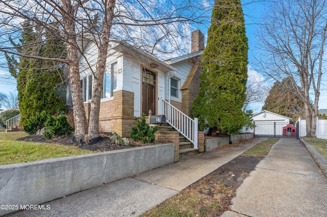 view of front of home with a garage and an outdoor structure