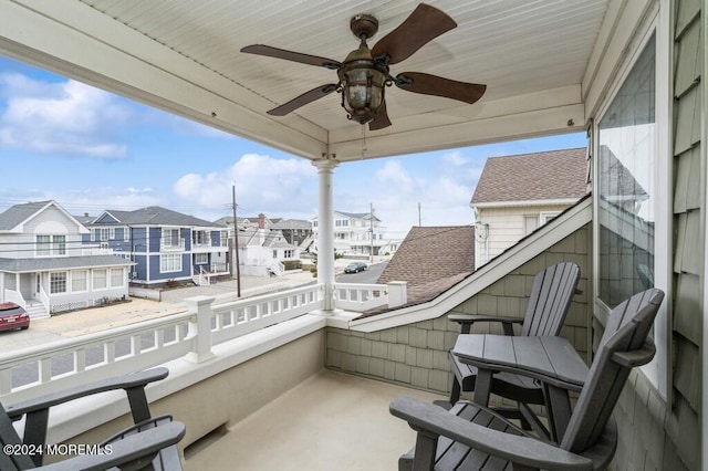 balcony with a residential view and ceiling fan