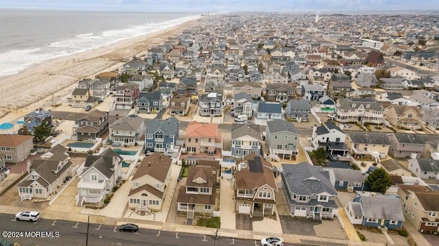 birds eye view of property featuring a residential view, a water view, and a view of the beach