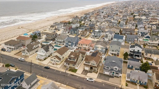 bird's eye view featuring a residential view, a water view, and a view of the beach