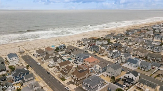 birds eye view of property with a residential view, a beach view, and a water view