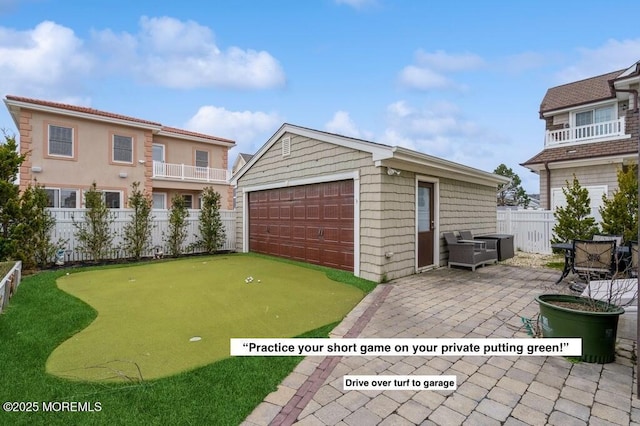 detached garage featuring fence