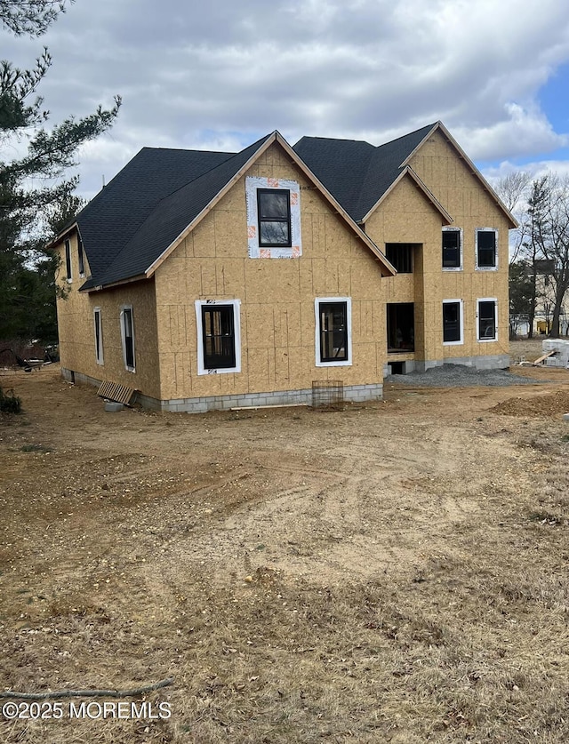 back of property featuring a shingled roof