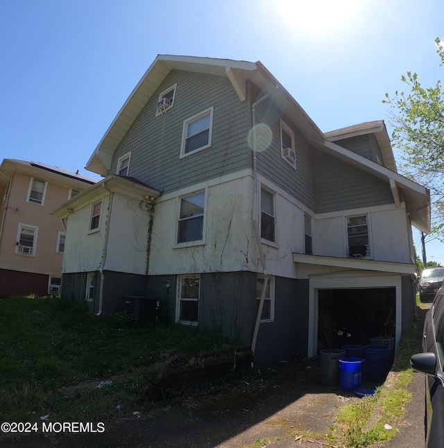 exterior space with a garage and central air condition unit