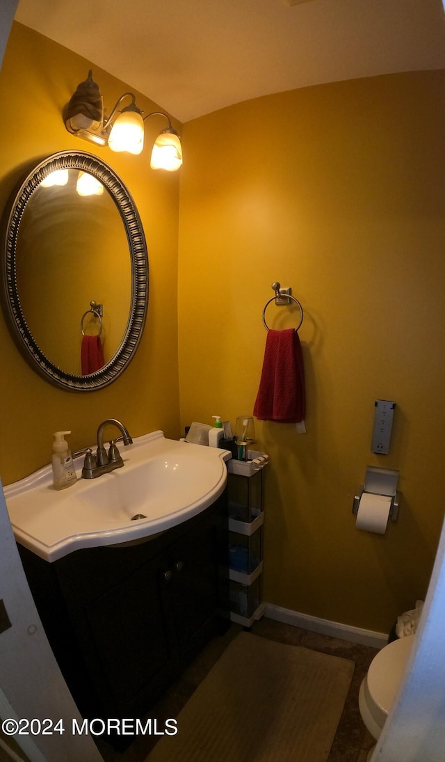 bathroom with tile patterned floors, vanity, and toilet