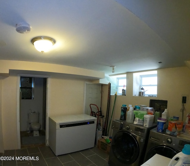 laundry room featuring washing machine and dryer and tile patterned floors