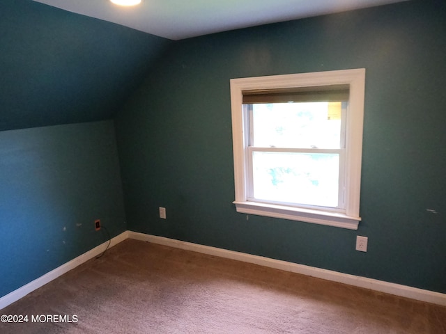 bonus room featuring carpet floors and vaulted ceiling