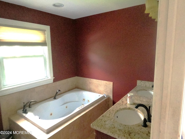 bathroom featuring double sink vanity and a relaxing tiled tub