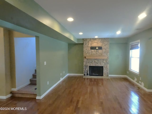 unfurnished living room featuring a fireplace and hardwood / wood-style flooring