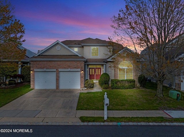 front of property featuring a garage and a lawn